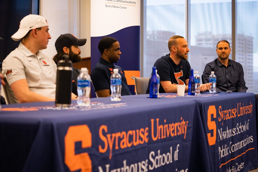 Mike Lang speaks to students and Professor Jordan Kligerman and the rest of the team watches on