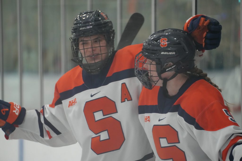The picture shows Bryn Saarela celebrating with Charli Kettyle after a goal. 