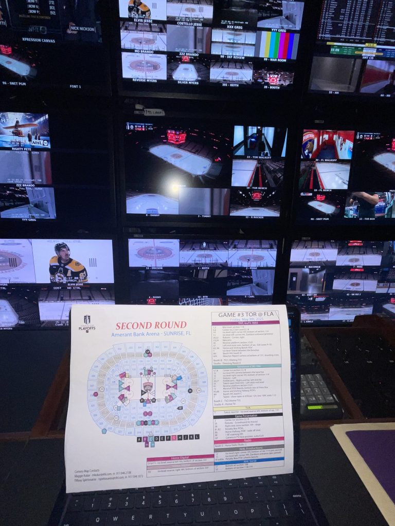 Mandelbaum sitting in the directing chair, prepping and reviewing material before puck drop @2025 Joel Mandelbaum