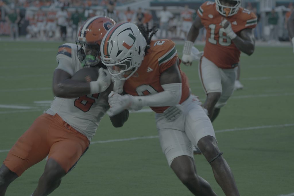 Syracuse running back Yasin WIllis takes a hit from Miami defender