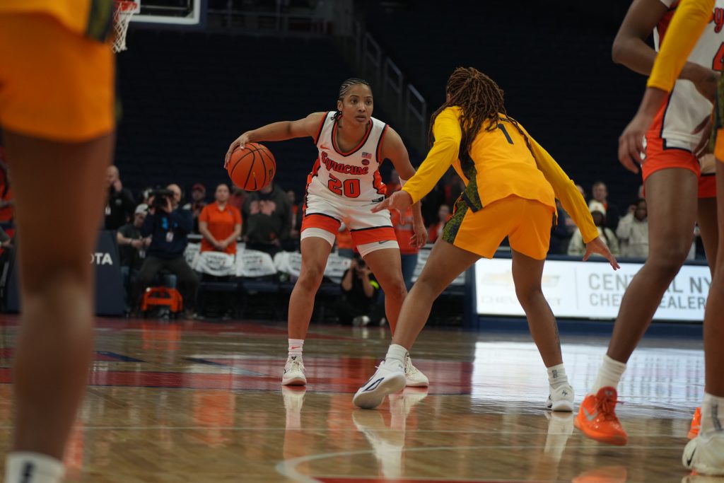 A Syracuse women’s basketball player, Dominique Darius, dribbles at the top of the arc while being guarded by a Cal defender during the triple-overtime game at the JMA Wireless Dome. Photo by Gaby Waksberg.