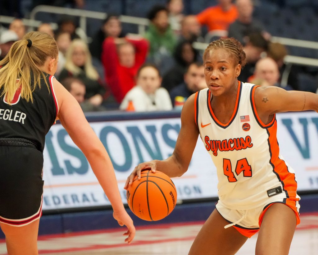 Uche Izoje dribbles the ball.